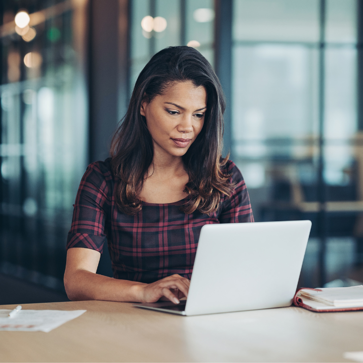 Woman looking up ASRM Academy on laptop