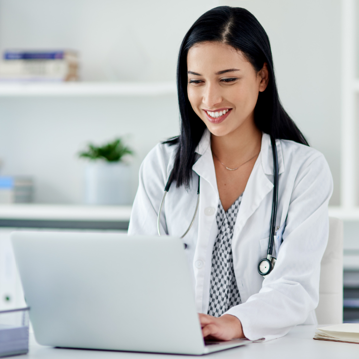 Healthcare Profession works on laptop to continue education 
