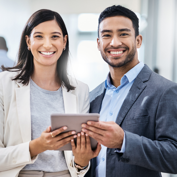 Professional managers looking over work on a tablet