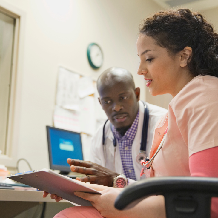 Two healthcare professions discussing correct coding procedures 