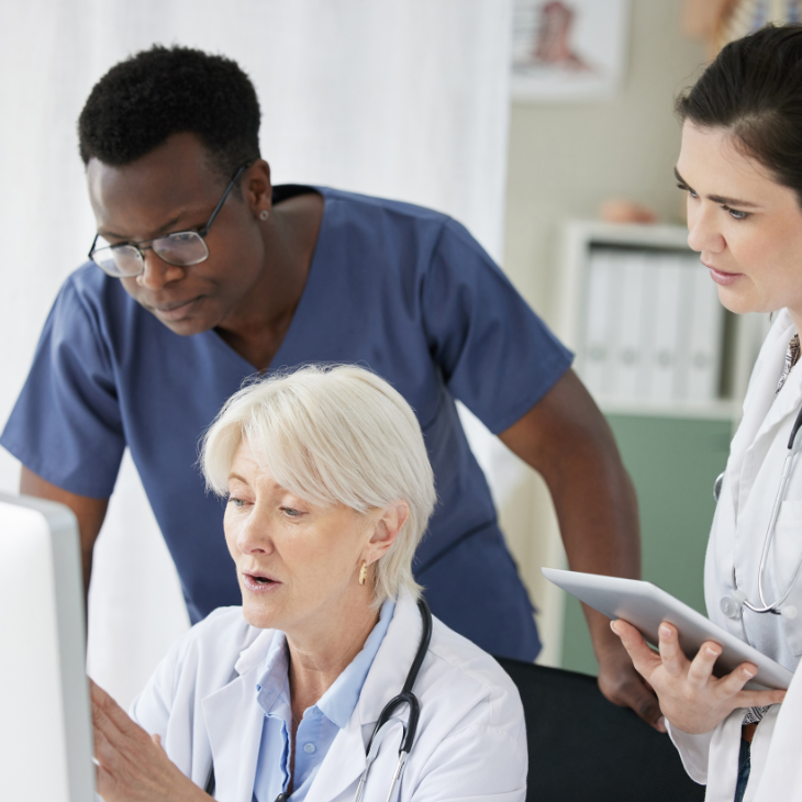 Healthcare professionals gather around to read practice guidance